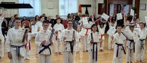 Students receiving new belts and certificates